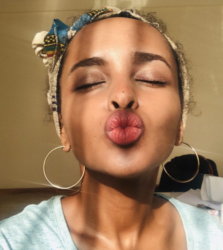 Black woman eyes closed kissing face