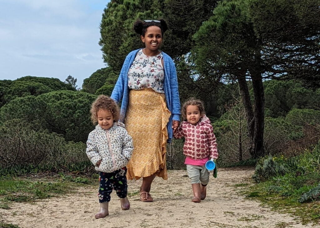 black mother with twin daughters in a national park