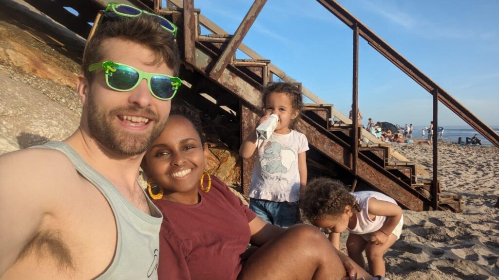 mixed race family on a beach in portugal