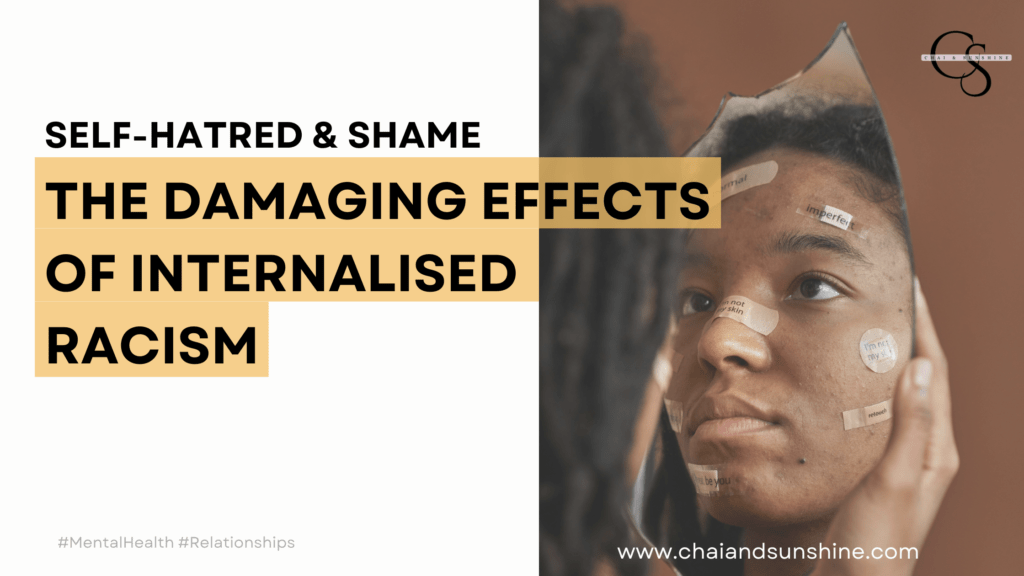 Self-hatred and shame: The Damaging Effects of Internalised Racism, linked to a blog post by chai and sunshine. Picture of black woman looking in the mirror with bandaids on her face that have several negative words on them.