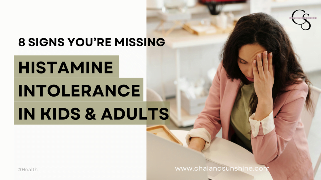 Histamine intolerance in kids & Adults - 8 signs you're missing, with a picture of a professional woman holding her head, linked to blog post on "what are the signs of histamine intolerance?"