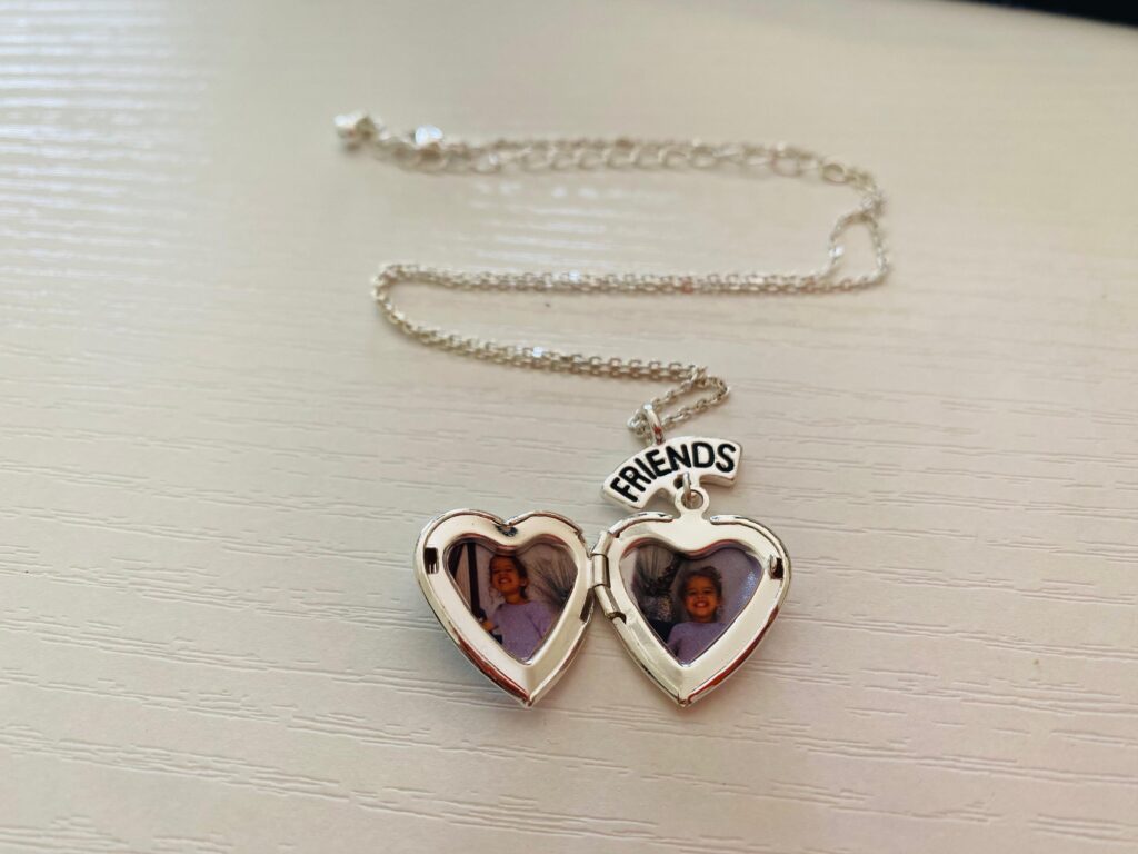heart locket with pictures of toddlers inside