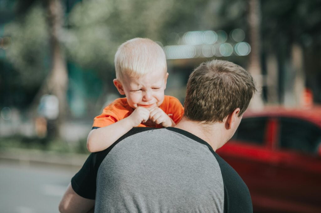 Toddler Separation Anxiety at School - father carrying a crying toddler boy