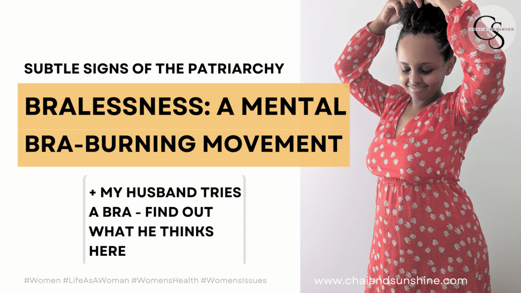 Subtle Signs of the Patriarchy, Bralessness: A Mental Bra-Burning Movement + My Husband Tries a Bra - Find out what he thinks here; Black woman in red dress, arms above her head and looking down, smiling