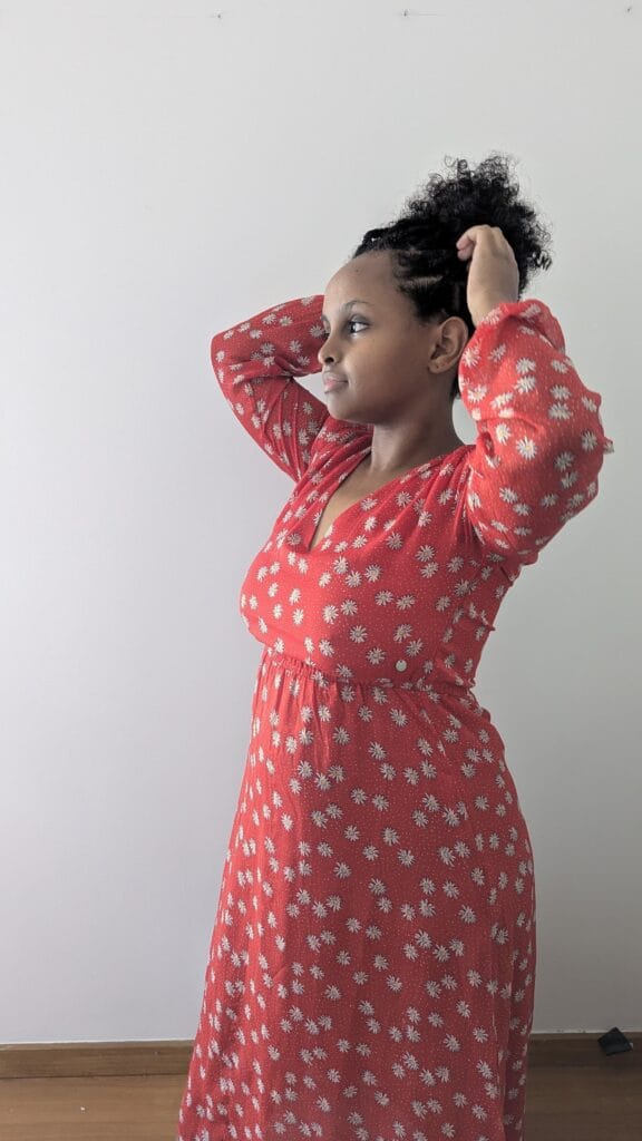 Subtle Signs of the Patriarchy, Bralessness: A Mental Bra-Burning Movement; black woman in red dress
