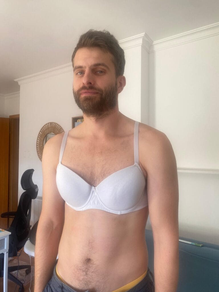 bralessness: a mental bra-burning movement, subtle signs of the patriarchy, white man in white bra, looking miserable