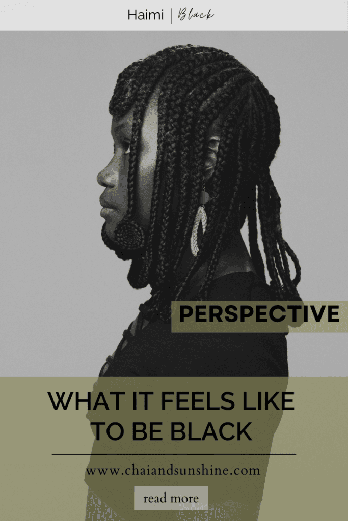 What it feels like to be black, a perspective, a chaiandsunshine.com blog post, a black woman in black clothes, with african braids, side profile, grayscale